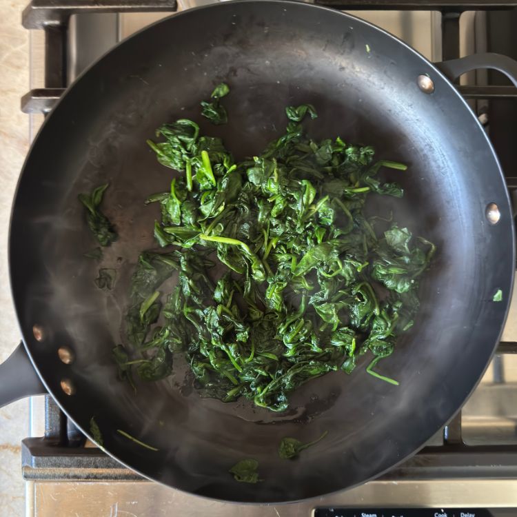 Spinach cooked for Sauteed Spinach with Podi on a pan