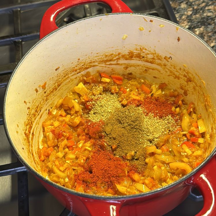 Adding traditional Indian spices to create the masala base for Tofu Burji