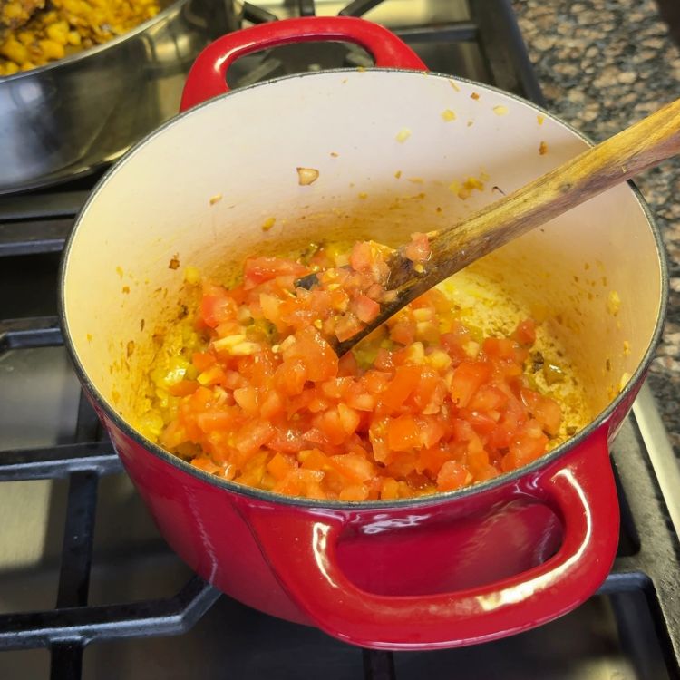 Adding tomatoes to create the masala base for Tofu Burji