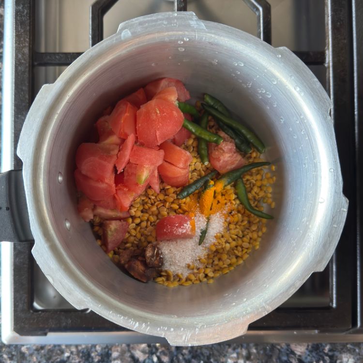 all ingredients for tomato dal in a cooker