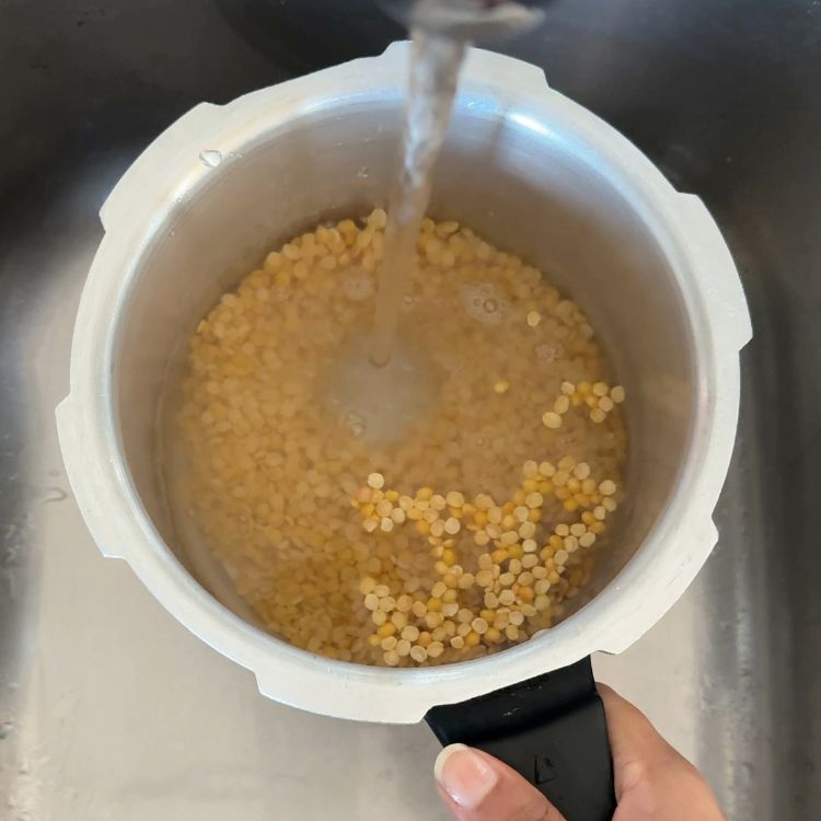 washing toor dal in a pot