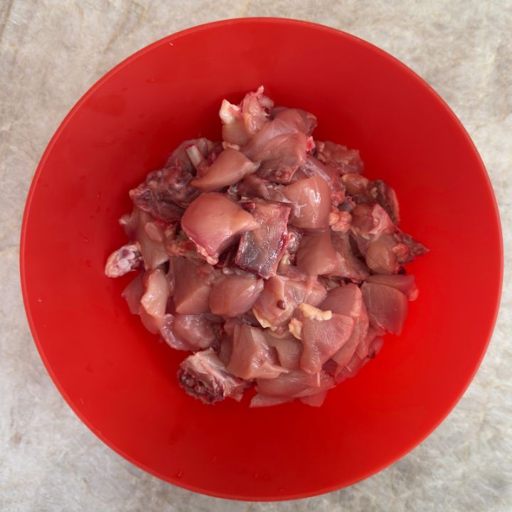 whole chicken cut into medium pieces in a bowl