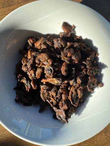 Hot and spicy Indian style mushroom fry served in a traditional bowl, ready to eat