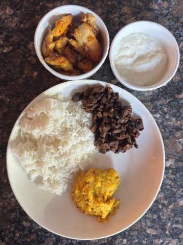 Delicious and Nutritious South Indian Tomato Pappu Thali featuring Tomato Pappu, White Rice, Oven Baked Chicken Thighs, Mushroom Fry, and Homemade Yogurt.